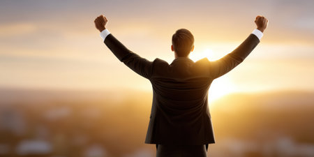 Successful business professional celebrating victory at sunrise smart business leader raising arms in triumphの素材