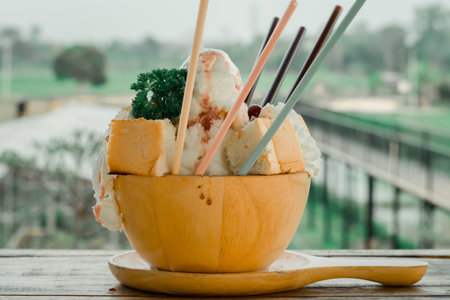 Ice cream, blueberries and toast on wooden table with wooden cup.の写真素材