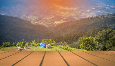 Empty brown wooden table, camping and tent on the top of the hill at north of Thailand.の写真素材