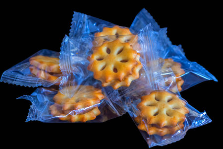 Close up to cookies in a clear plastic bag on a black background.の写真素材