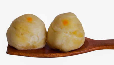 Dessert Chinese pastry or mooncake for Chinese new year on wooden ladle and the isolate white background.の写真素材