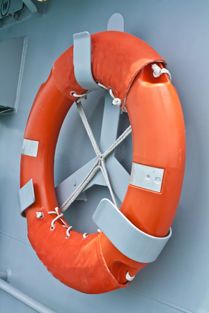 The red lifebuoy hanged on the warship