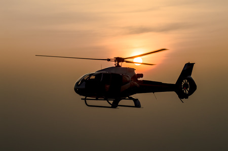 The patrol helicopter flying in the skyの写真素材