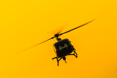 The patrol helicopter flying in the skyの写真素材