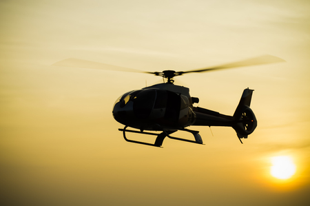 The patrol helicopter flying in the skyの写真素材