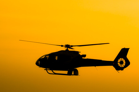 The patrol helicopter flying in the skyの写真素材