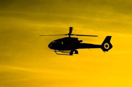 The patrol helicopter flying in the skyの写真素材