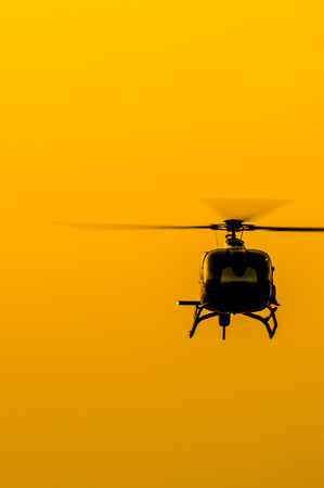 The patrol helicopter flying in the skyの写真素材