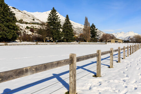 sunny winter clear sky and wooden fence
