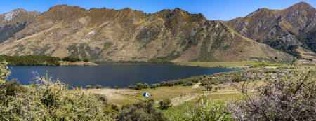 panoramic immage of Campsite at Moke Lake in a summer with blurry Foregroundの写真素材