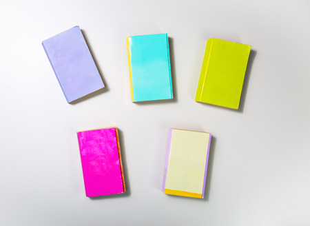 colorful books with blank cover isolated on white