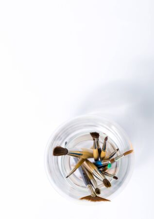 top view of paint brushes in jar with white space at the topの写真素材