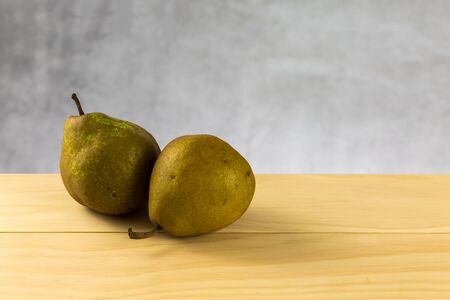 pears on wood table and concrete backgroundの写真素材