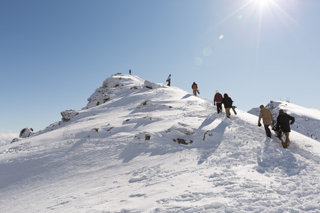 QUEENSTOWN, NEW ZEALAND - AUGUST 6: Unidentified skiers and snowboarders hike on the top of The Remarkables Ski Area on August 6, 2015 in Queenstown, South Island, New Zealandのeditorial素材