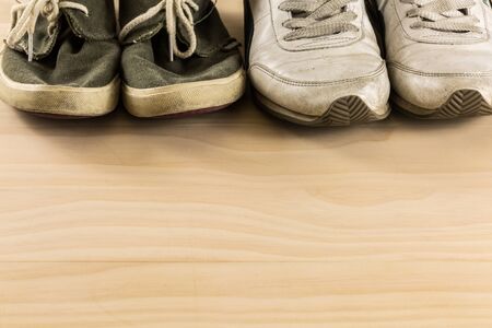 men and women shoes on wooden floorの写真素材