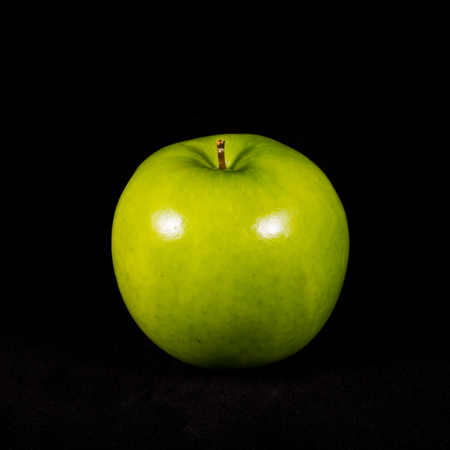Green apple isolated on black backgroundの写真素材