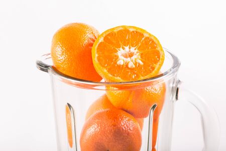 orange in blender isolated on whiteの写真素材