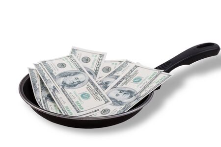 Dollar bills in used Non stick frying pan isolated on whiteの写真素材