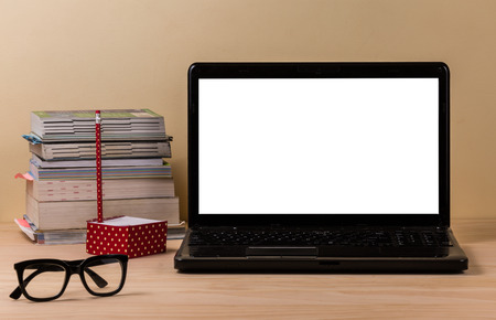 Laptop on wooden table and concreter background