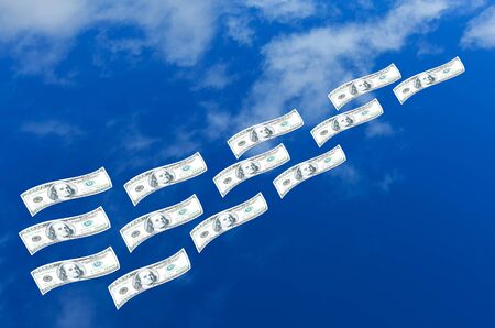 Dollars money flying in blue skyの写真素材