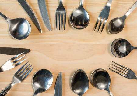 overhead shot image of cutlery background on wooden tableの写真素材