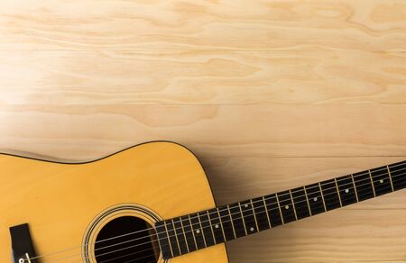 Acoustic guitar on wooden backgroundの写真素材