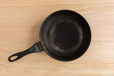 non stick frying pan on wooden backgroundの写真素材
