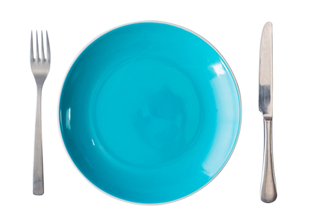 green plate with fork and knife isolated on whiteの写真素材