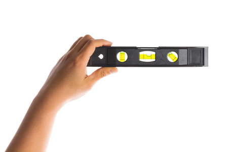 hand holding construction bubble spirit level tool isolated on whiteの写真素材