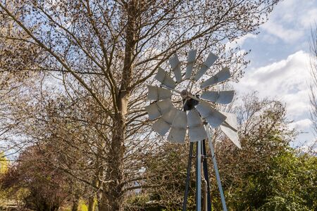 old small windmill decorated in the gardenの写真素材