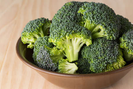fresh broccoli on wooden boardの写真素材
