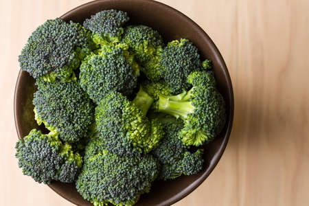 fresh broccoli on wooden boardの写真素材