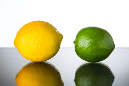lime and lemon on glass tableの写真素材