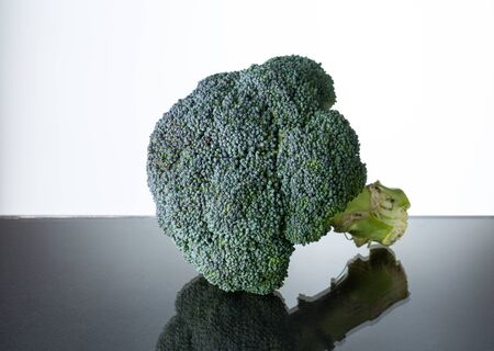 fresh broccoli on glass tableの写真素材