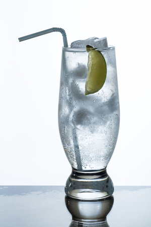 glass of lemonade and ice with slice of limeの写真素材
