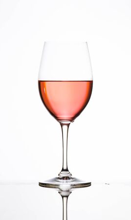glass of Rose on glass table and white backgroundの写真素材