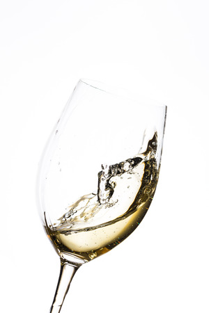 glass of white wine on white backgroundの写真素材