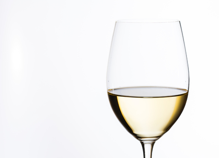 glass of white wine on white backgroundの写真素材