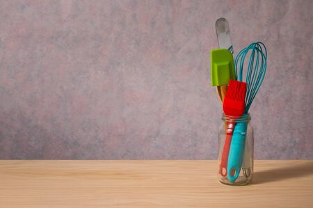 colourful kitchen utensils on wooden table