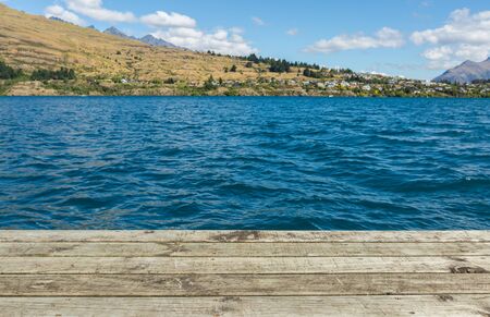 wooden pier with lake and mountain backgroundの写真素材