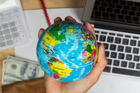 travel concept image with hand holding globe