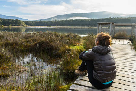 woman hiking at kepler track in Te Anau, New Zealandの写真素材