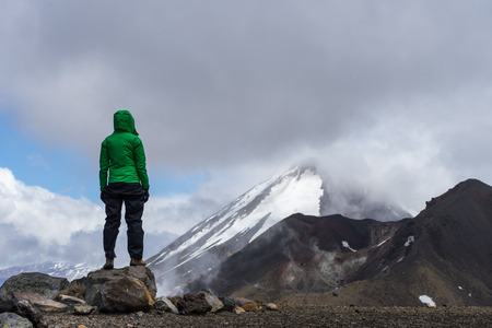 Woman hiker looking at Mt Ngauruhoe in Tongariro national park, New Zealand