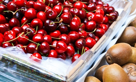 Cherries and kiwi in the boxの写真素材