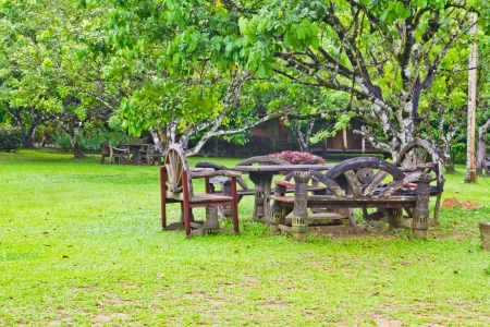 Wooden tables and chairs on the grassの写真素材