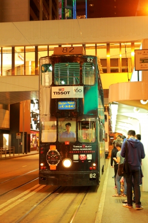 Hong Kong Double-Decker Tram speeding through the Wan Chai district of Hong Kong Island  Hong Kong has the most double-deck trams in the world and millions of people commute on them annually のeditorial素材