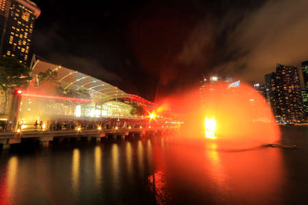 The public enjoying the light show at MBS with the city nights cape as the back drop  The light show named Wonder full lasted for 13mins  This is the free showcase of stunning visual effects with interweaving lasers, video projectors and giant streaming wのeditorial素材