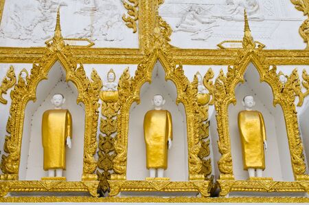 Buddha on the wall at the temple of Thailand の写真素材