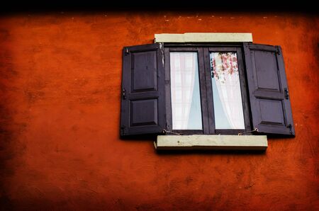 Vintage window on orange cement wallの写真素材