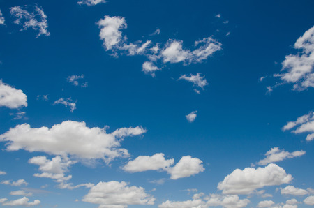 Blue sky background with big and small clouds.の写真素材